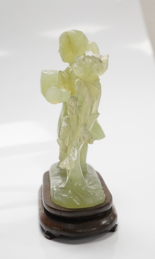 A Chinese green bowenite jade figure on hardwood stand, 14.5cm. Condition - good